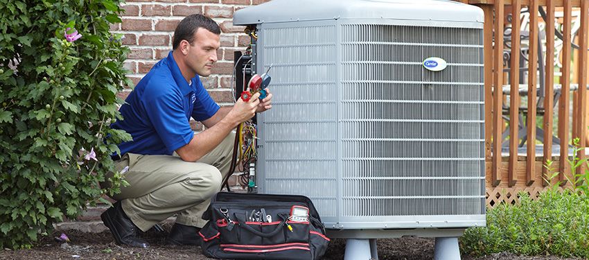 man repairing carrier air conditioner